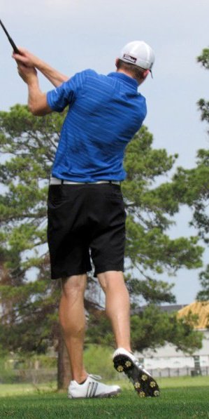 A golfer swinging