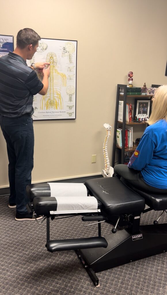 a chiropractor explaining chiropractic to a patient