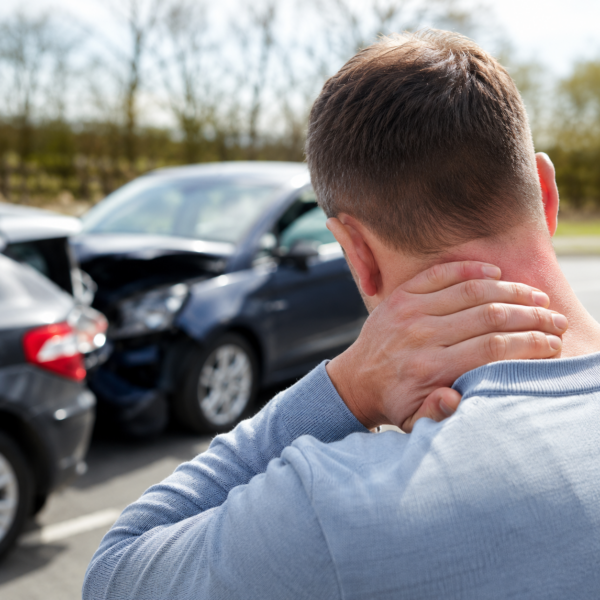 a person holding his neck after an auto accident injury